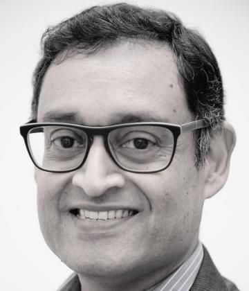 Girish Menon smiling towards the camera