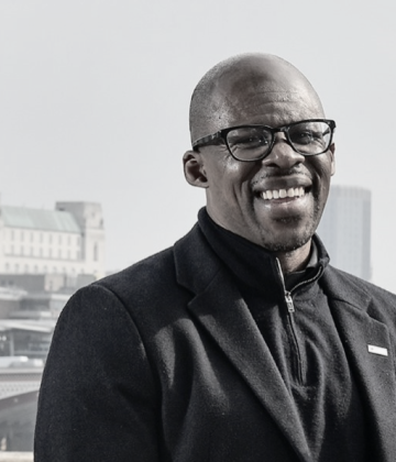 Paul Amadi smiling towards the camera