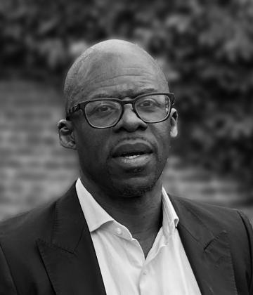 Black and white image of board member, Paul Amadi